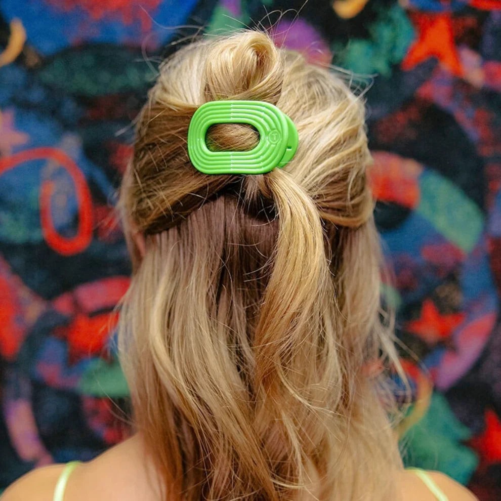 Doodlations Coffee Bar & Boutique lime green flat round hair clip with textured design.