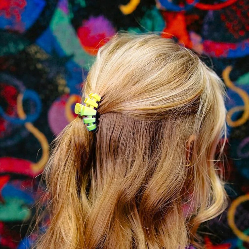 Doodlations Coffee Bar & Boutique lime green gradient segmented claw hair clip holding blonde hair in a ponytail.