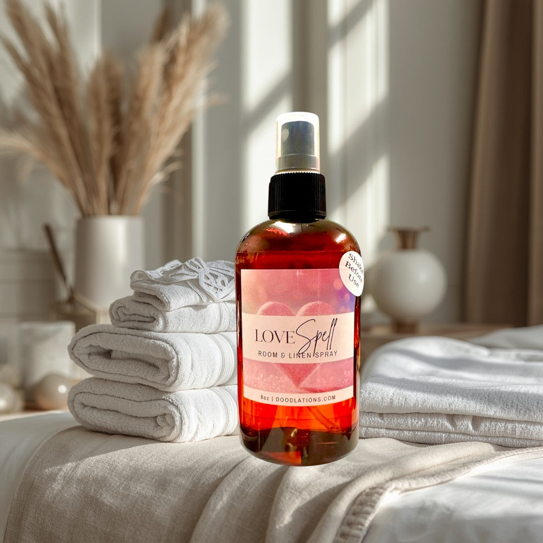 Doodlations Love Spell room and linen spray in amber bottle with pink label featuring hearts. 8oz.