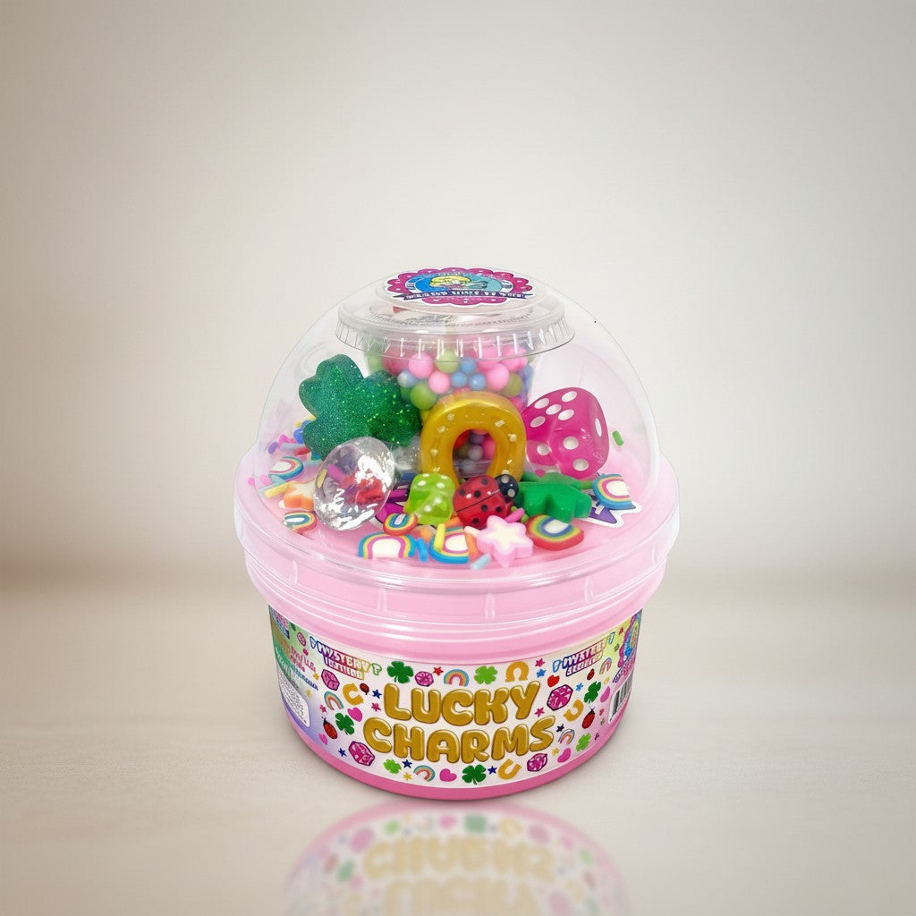 Doodlations Coffee Bar & Boutique Lucky Charms mystery slime container with colorful charms like dice, ladybugs, and shamrocks.
