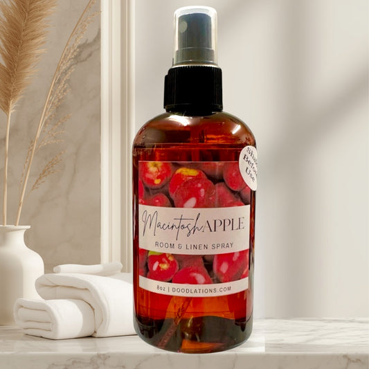 Doodlations Coffee Bar & Boutique Macintosh Apple Room & Linen Spray in amber bottle with apple graphic. 8oz.