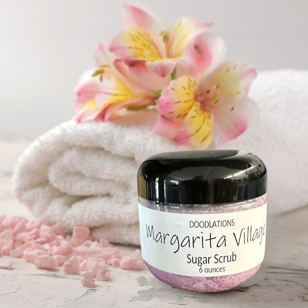 Doodlations Margarita Village Sugar Scrub in a clear jar with a black lid, 6 oz, light purple scrub.