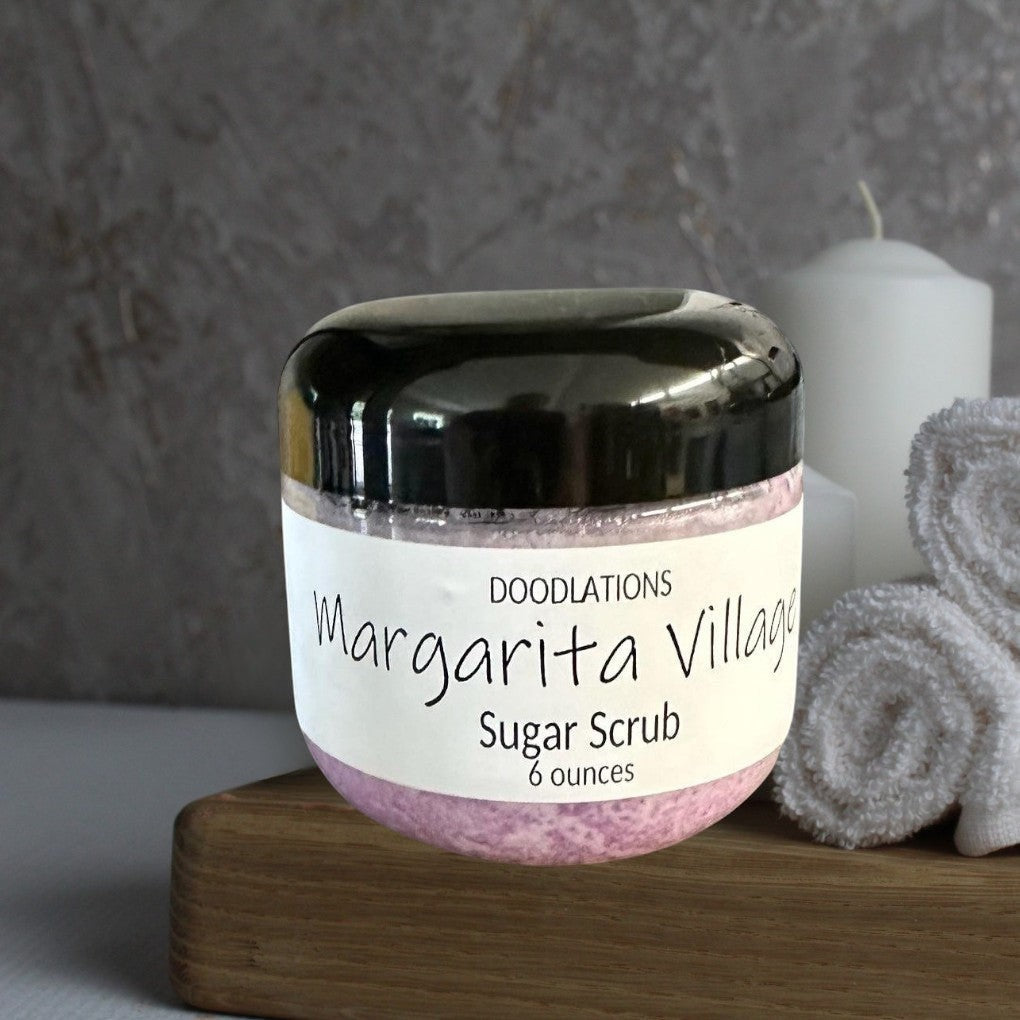 Doodlations Margarita Village sugar scrub in a clear jar with a black lid, 6 oz, light purple scrub.