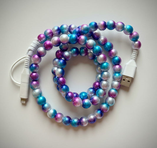 Doodlations Coffee Bar & Boutique mermaid beaded phone charger with Lightning and USB-C connectors in blue, purple, and silver.