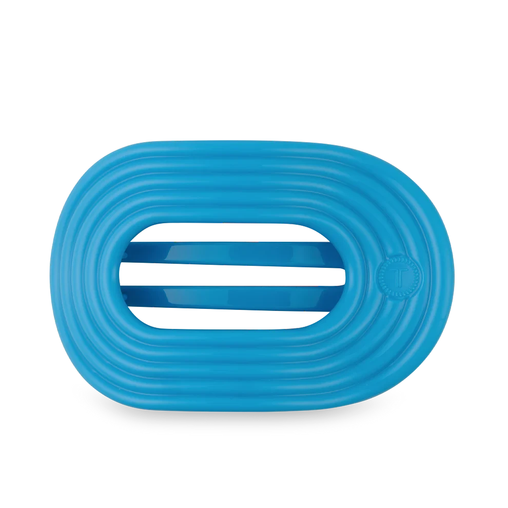 Doodlations Coffee Bar & Boutique vibrant blue flat round hair clip with a no-slip grip and textured design.