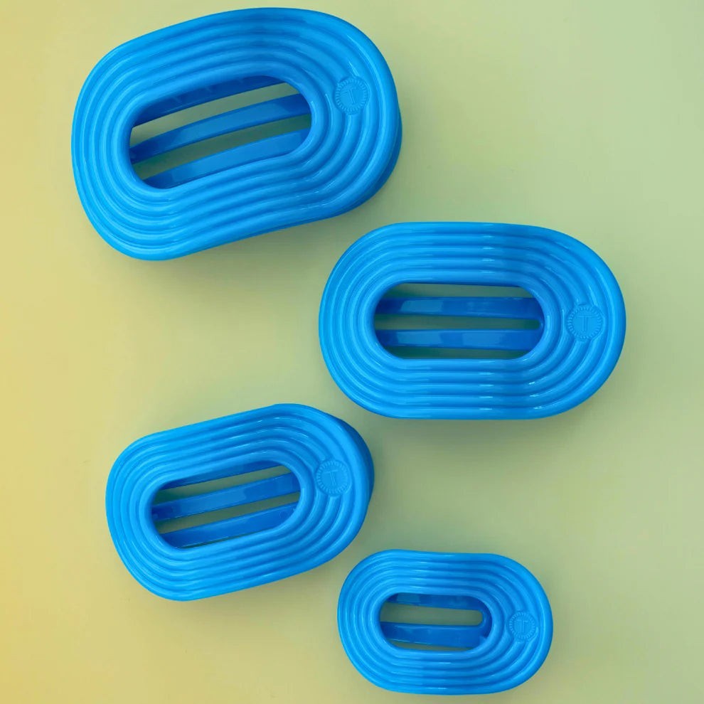 Doodlations Coffee Bar & Boutique Miami Vice blue flat round hair clips with grooved texture and internal bars.