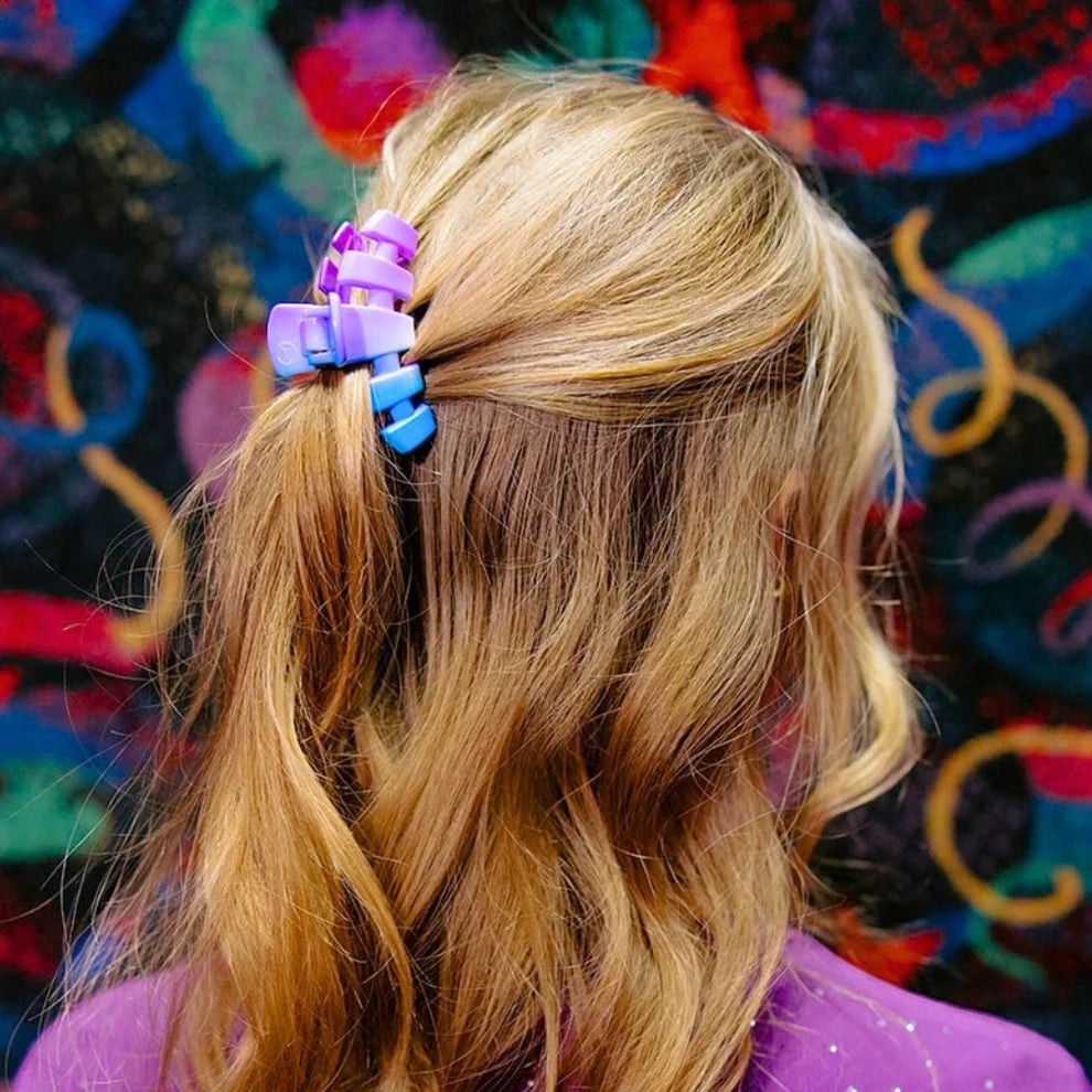Doodlations Coffee Bar & Boutique Miami Vice blue and purple gradient claw clip holding blonde hair in a ponytail.