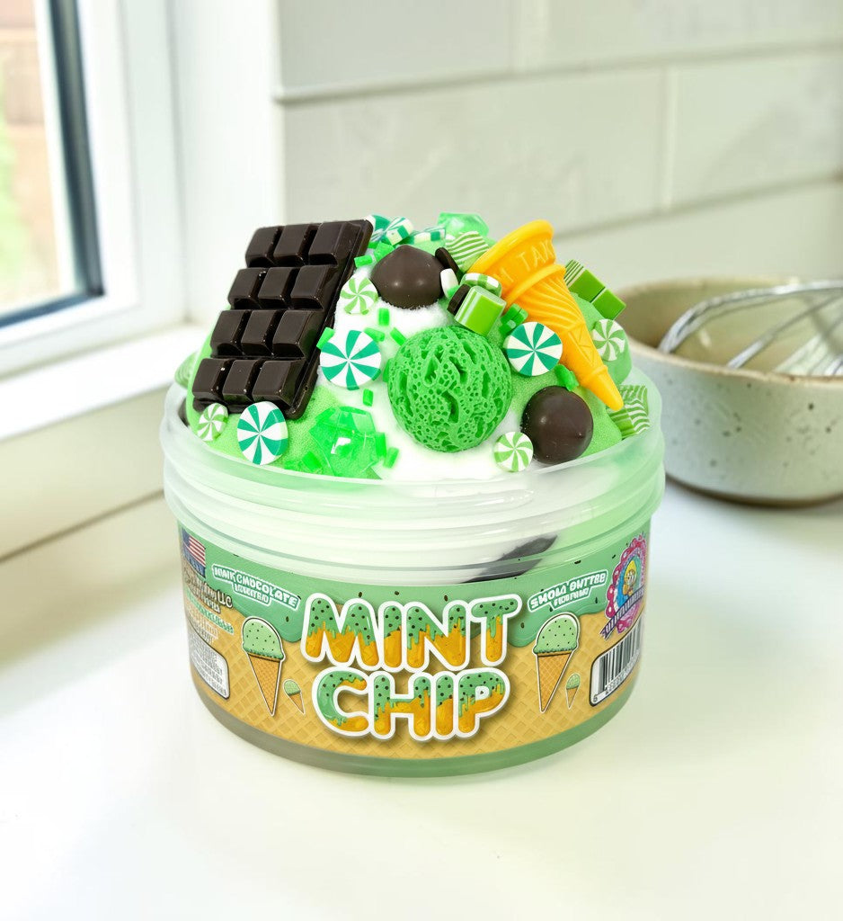 Doodlations Mint Chip slime with mint green, white, and beige swirls, topped with chocolate bar, ice cream cone, and candy charms.