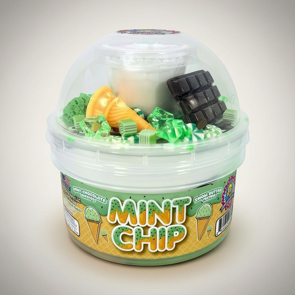 Doodlations Mint Chip snow butter slime in a clear tub, featuring mint green, white, and beige swirls with chocolate bar and ice cream cone charms.