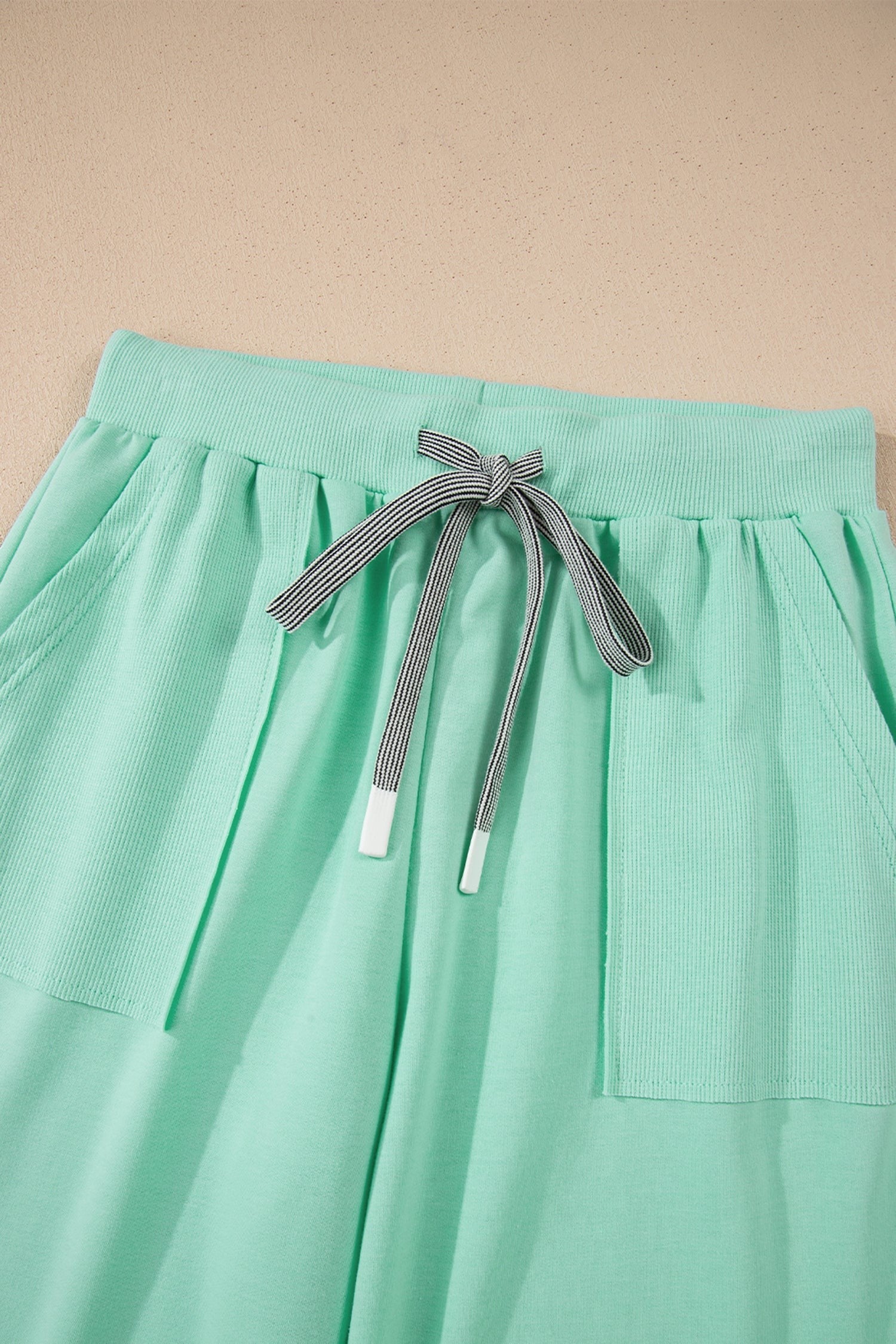 Doodlations Coffee Bar & Boutique mint green lounge set with drawstring pants and side pockets.