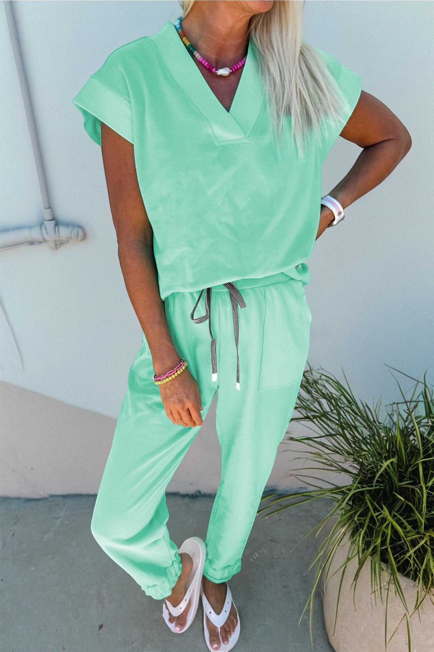 Doodlations Coffee Bar & Boutique mint green V-neck short sleeve lounge set with drawstring pants and pockets.