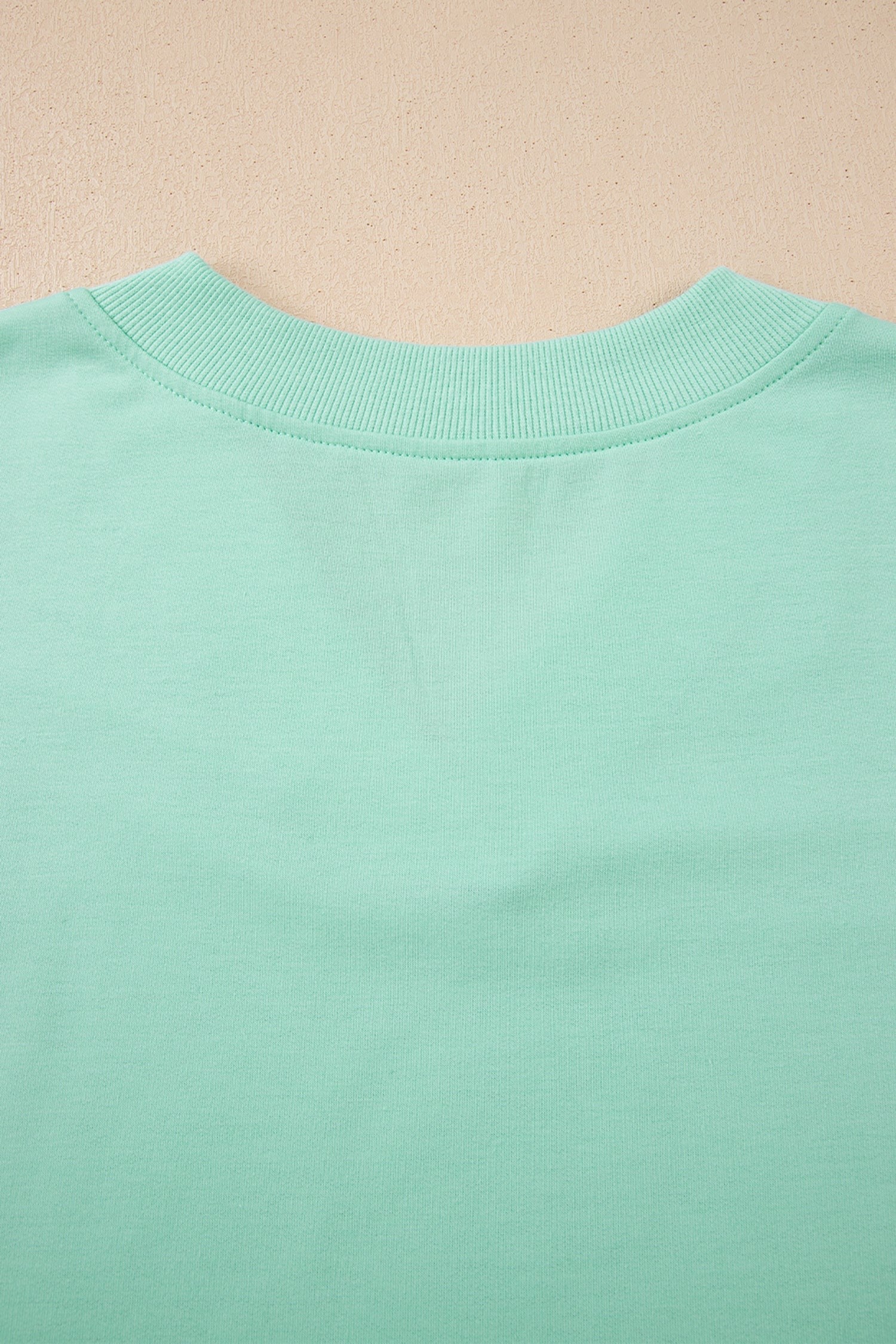 Doodlations Coffee Bar & Boutique mint green two-piece lounge set, soft fabric V-neck top and drawstring pants.