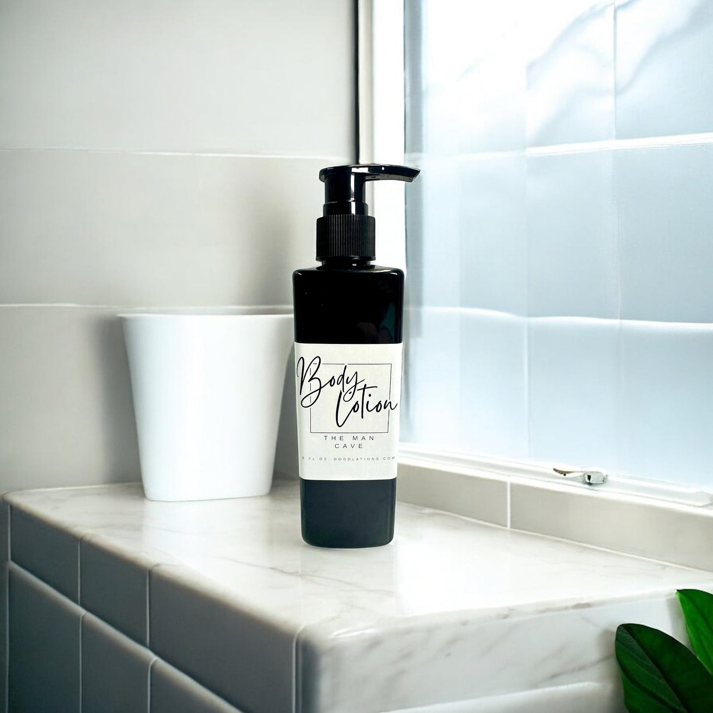 Doodlations Coffee Bar & Boutique black bottle of moisturizing body lotion with pump dispenser, 8oz size.