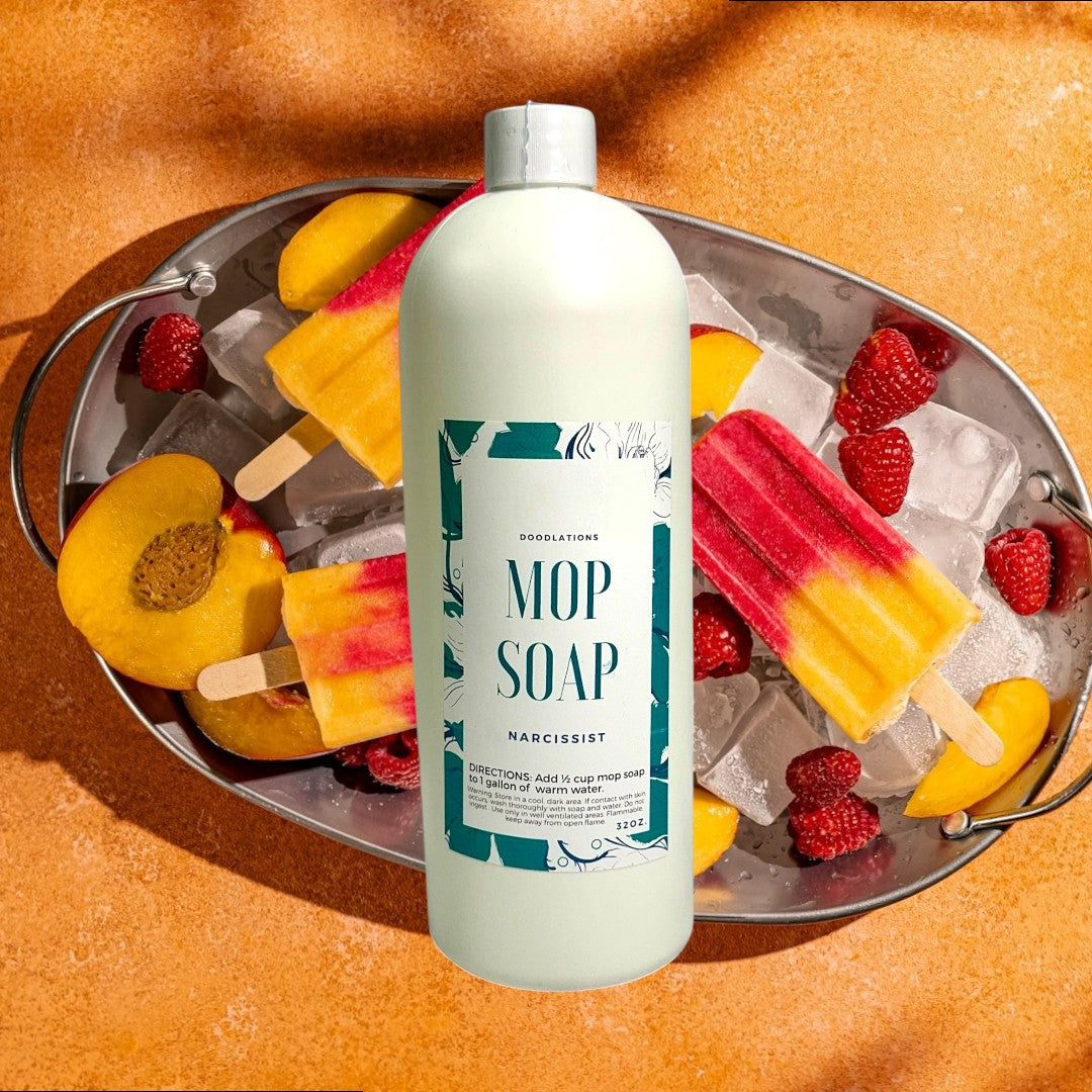 Doodlations Concentrated Mop Soap in The Narcissist scent, a peach and raspberry floral blend, 32 oz bottle.