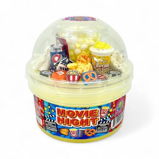 Doodlations Movie Night jelly cube clay slime with popcorn, soda, candy, and movie ticket charms. Scented like buttered popcorn.