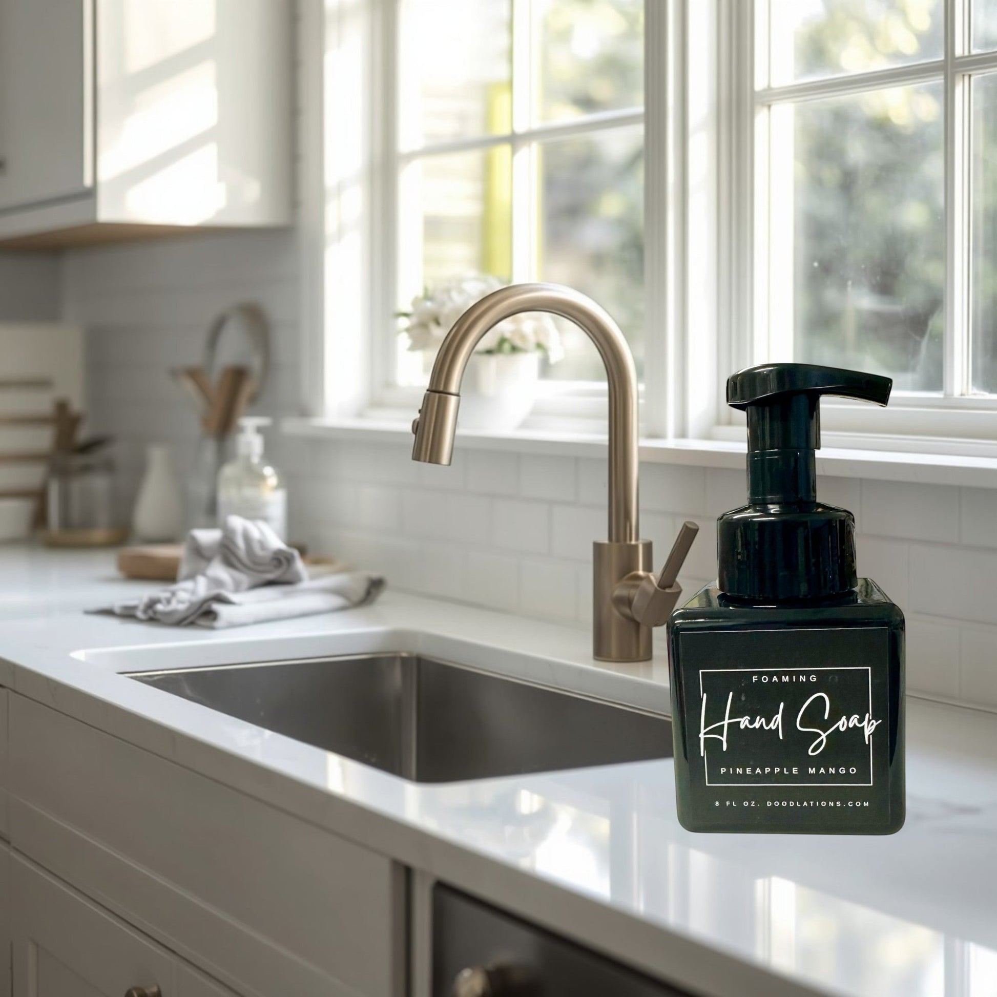Doodlations Pineapple Mango foaming hand soap in a black square bottle with a black pump. Tropical scent.