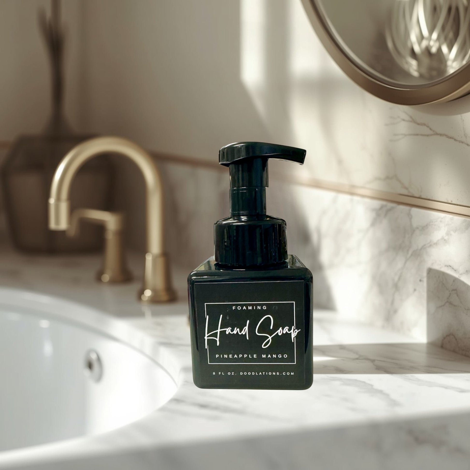 Doodlations Pineapple Mango foaming hand soap in a black square bottle with a black pump dispenser. Tropical scent.