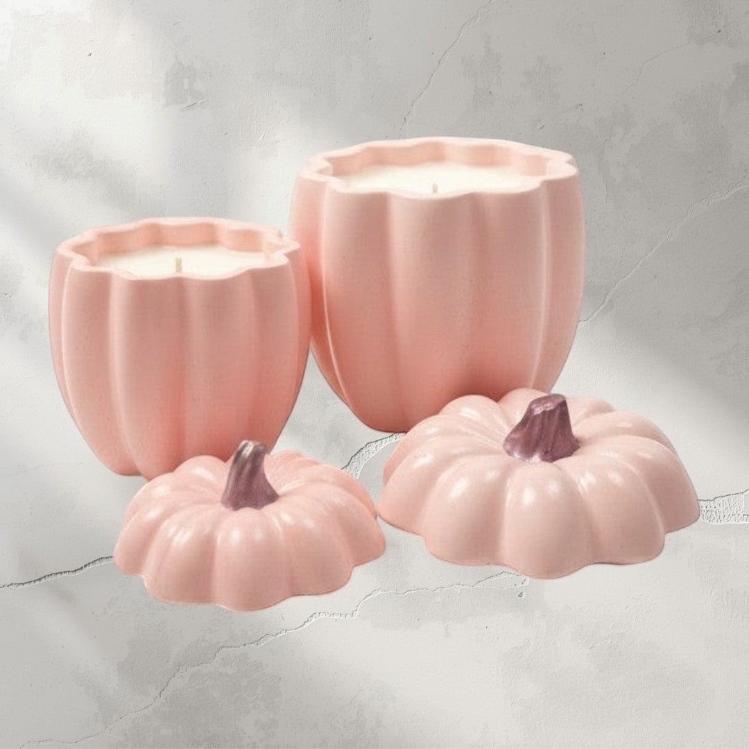 Doodlations pink ceramic pumpkin candles in two sizes with matching lids. Autumnal home decor.
