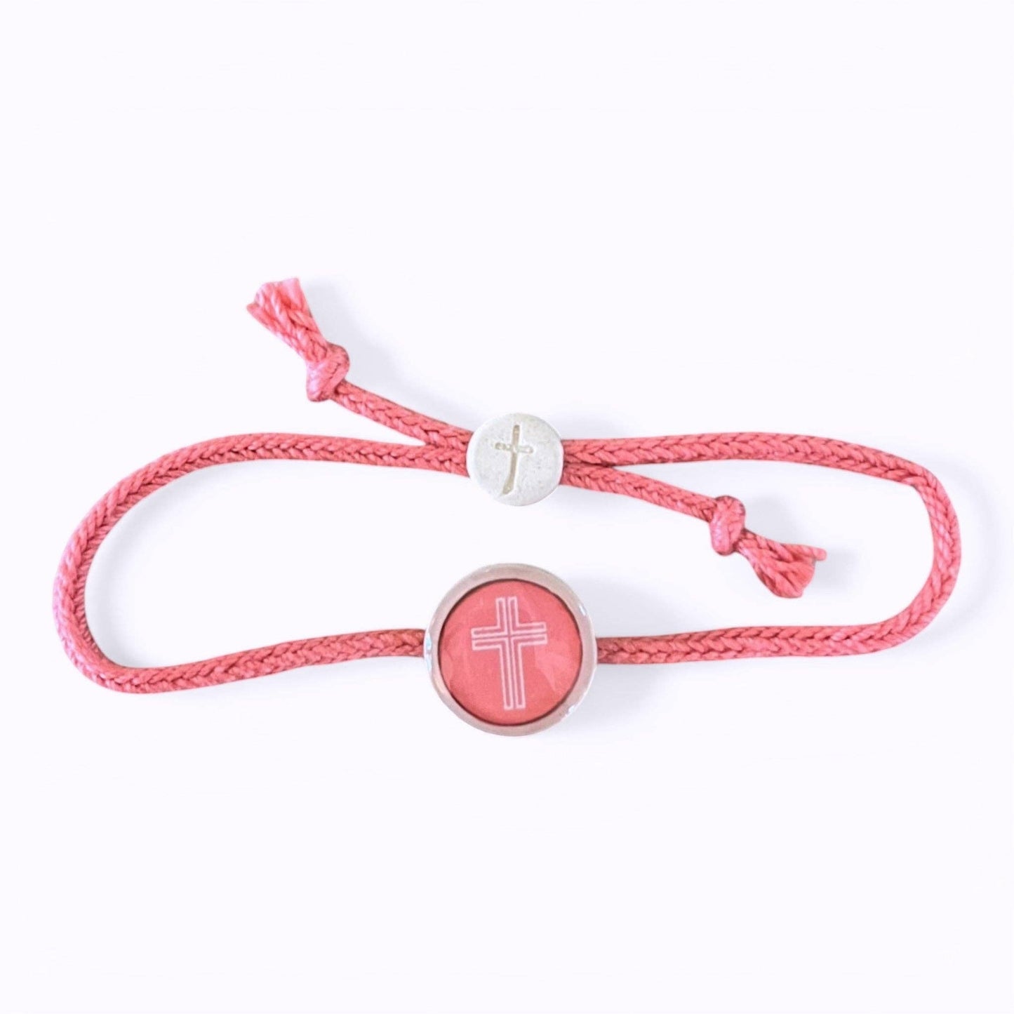 Doodlations Coffee Bar & Boutique pink cord bracelet with a central cross charm and a smaller cross bead.