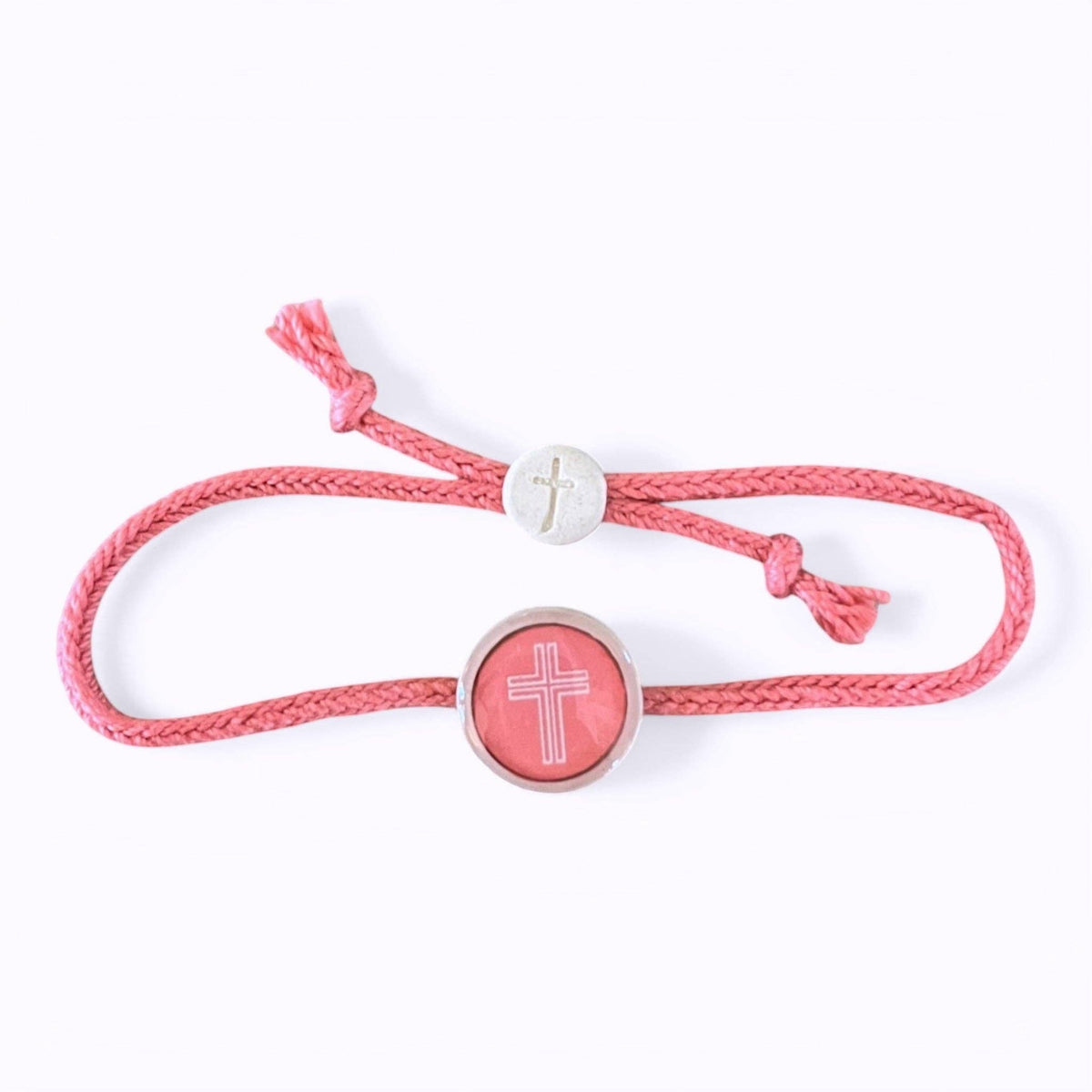 Doodlations Coffee Bar & Boutique pink cord bracelet with a central cross charm and a smaller cross bead.