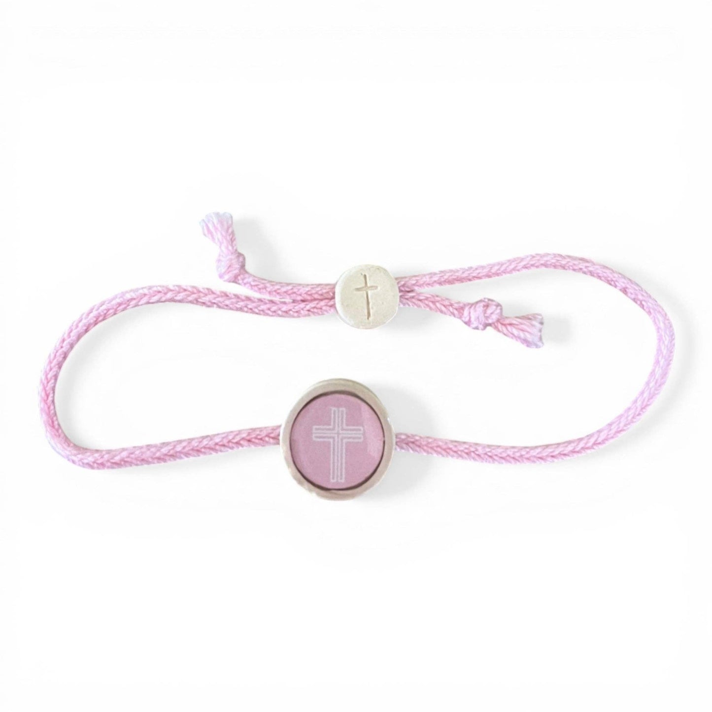 Doodlations Coffee Bar & Boutique pink cord bracelet with two cross charms, one silver and one pink.