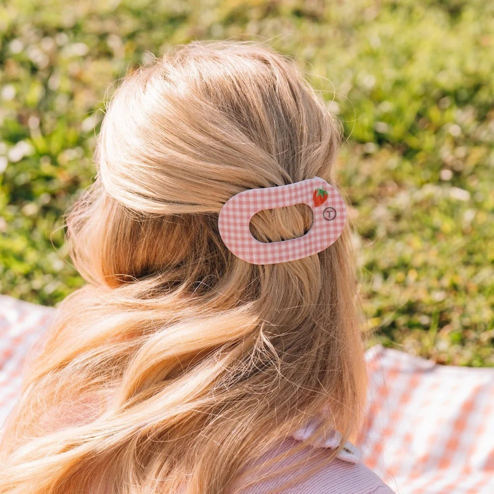 Doodlations pink gingham hair clip with strawberry accent, oval shape, for securing hair.