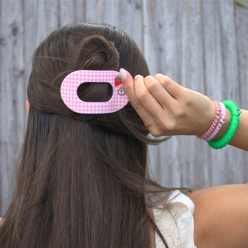 Doodlations pink gingham hair clip with strawberry accent, oval shape, for securing hair.
