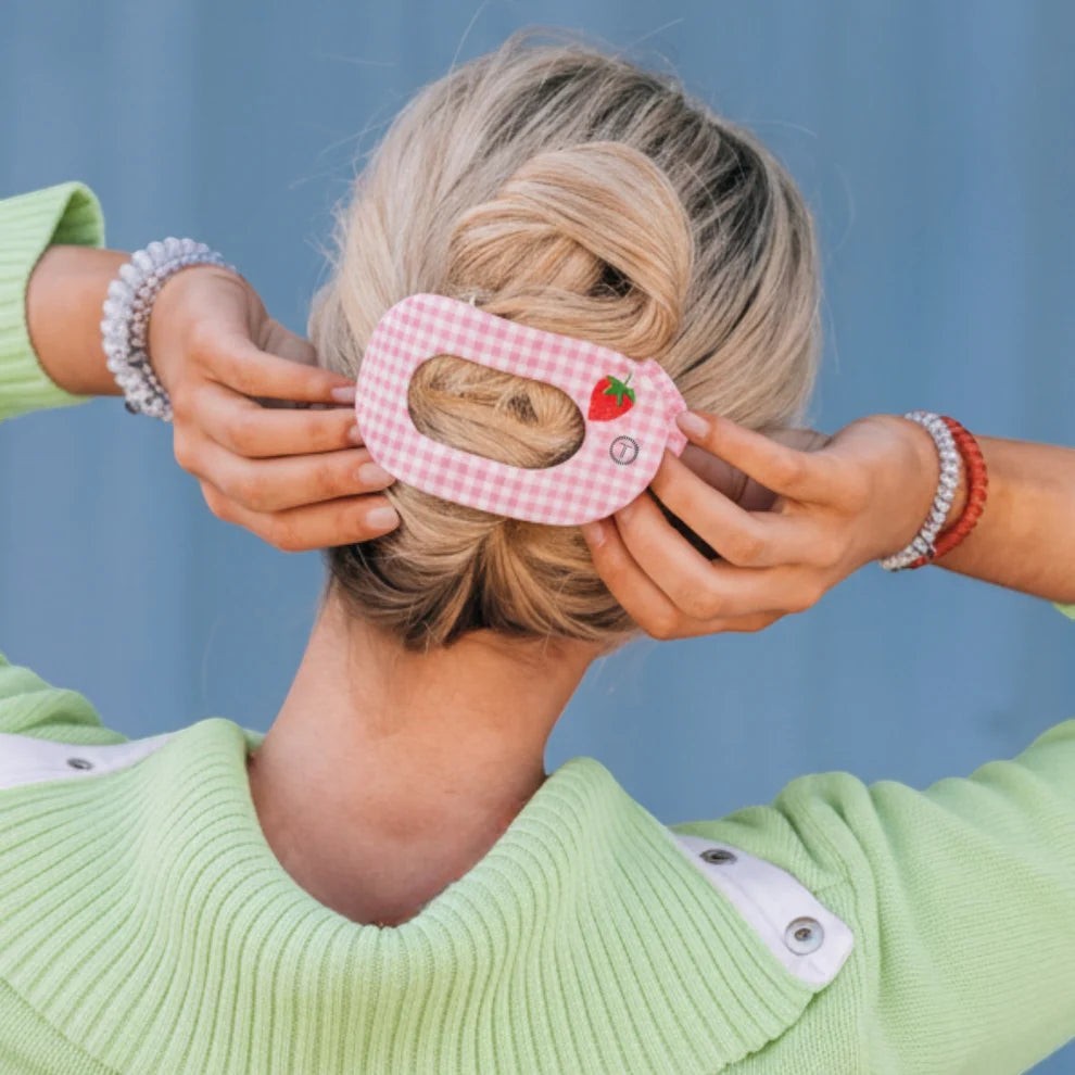 Doodlations pink gingham flat round hair clip with strawberry accent and button detail.