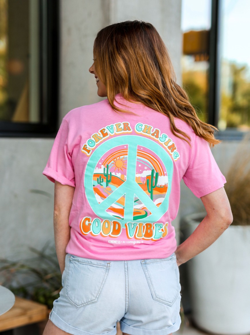 Doodlations Coffee Bar & Boutique pink cotton graphic tee with desert peace sign and "Good Vibes" text on back.