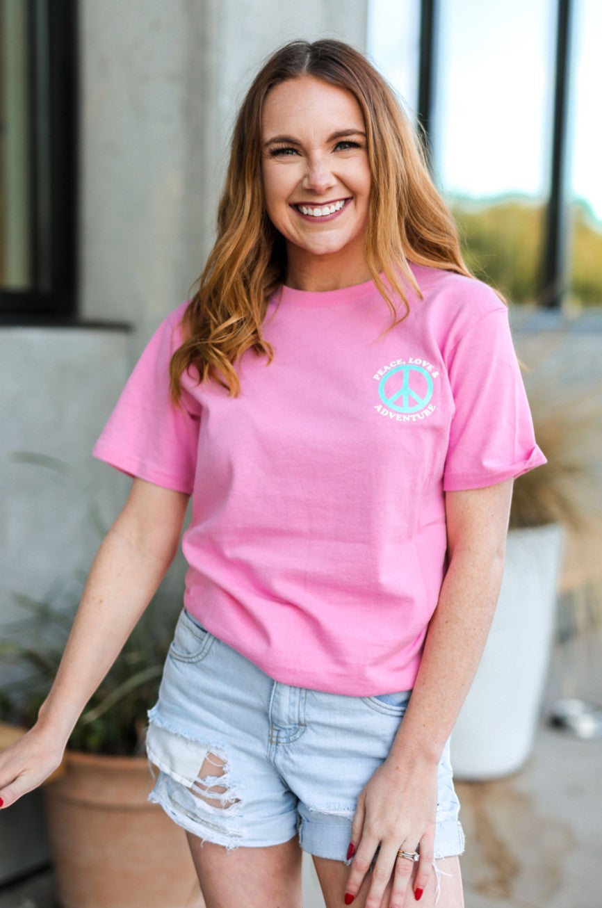 Doodlations Coffee Bar & Boutique pink cotton graphic tee with peace sign and desert landscape on back.