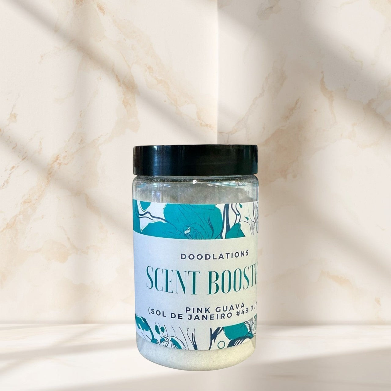 Doodlations Pink Guava laundry scent booster in a clear jar with a black lid and floral label.
