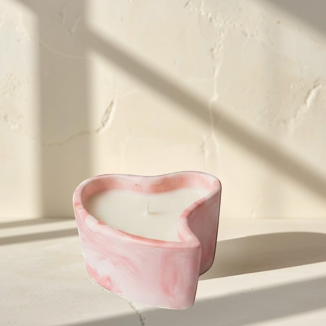 Doodlations Coffee Bar & Boutique marbled pink heart-shaped candle for cozy evenings.
