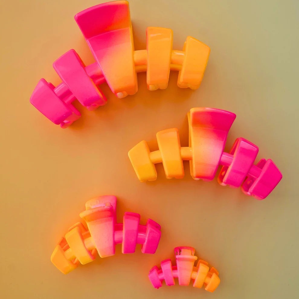 Doodlations Coffee Bar & Boutique pink and orange ombre segmented claw hair clip for secure styling.