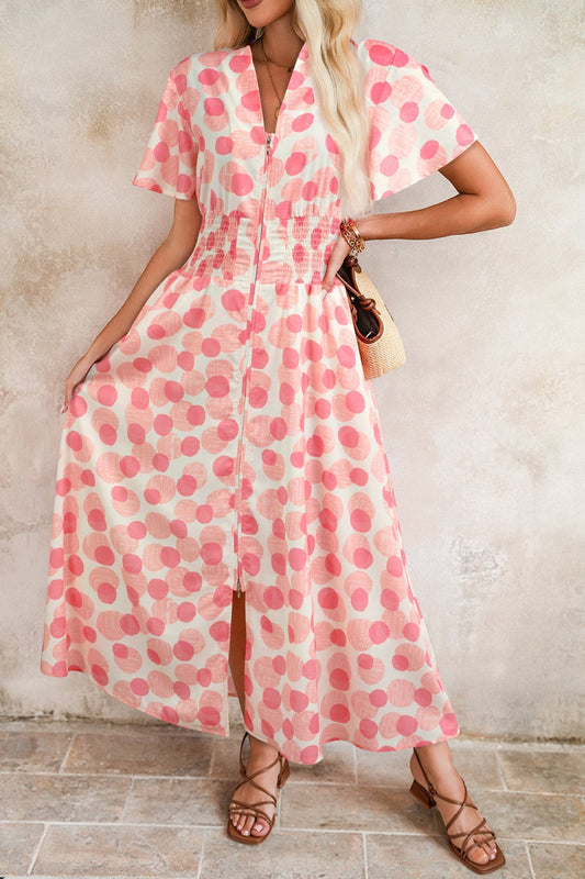 Doodlations Coffee Bar & Boutique pink and white polka dot midi dress with smocked waist and flutter sleeves.