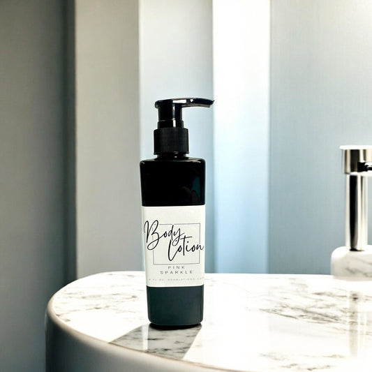 Doodlations Coffee Bar & Boutique Pink Sparkle moisturizing body lotion in a black pump bottle on a marble surface.