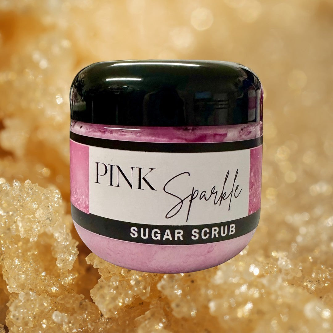Doodlations Pink Sparkle Sugar Scrub, a luxurious exfoliating body scrub in a pink hue with a white label.
