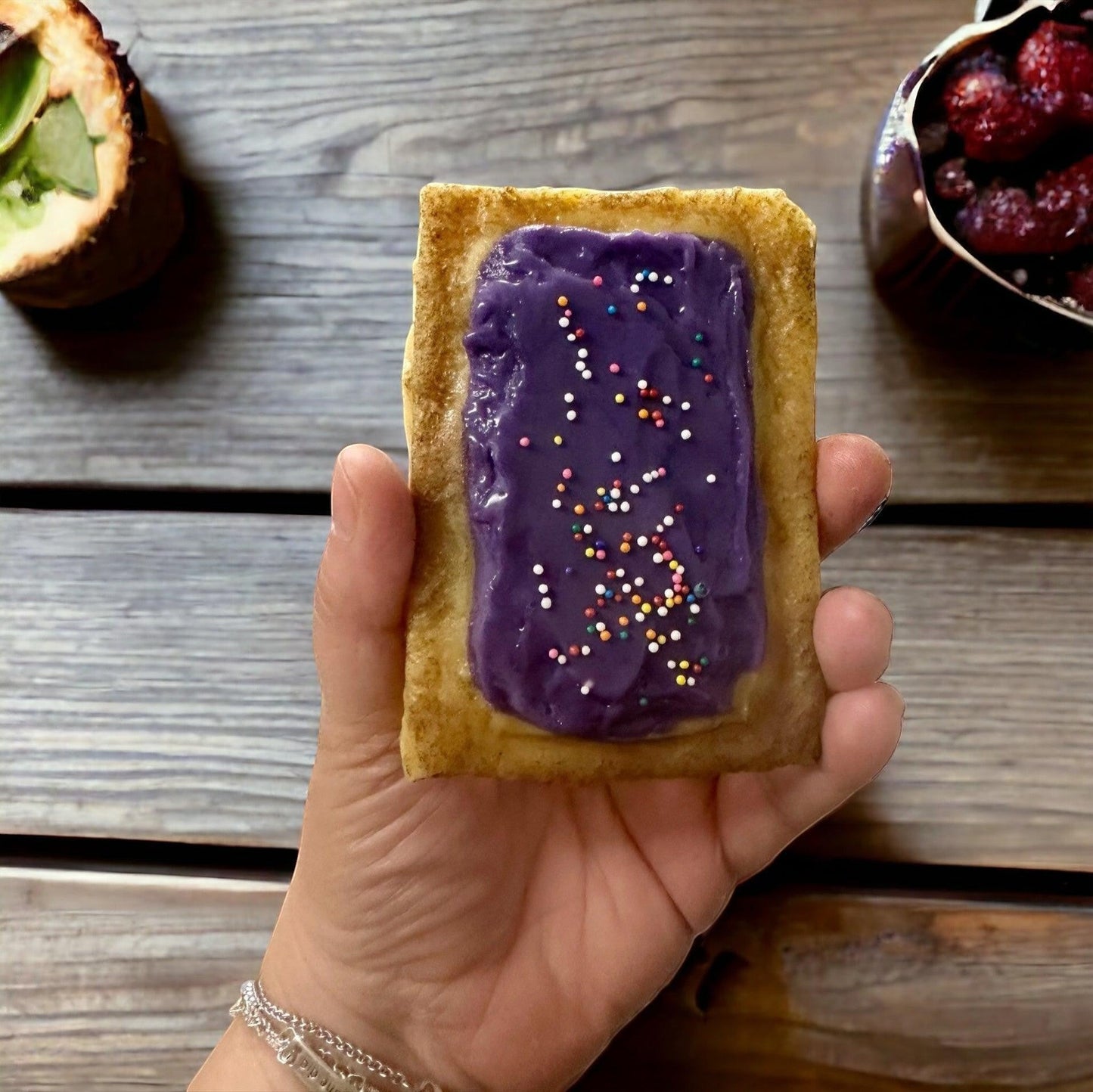 Doodlations Coffee Bar & Boutique PopTart wax melt with purple icing and colorful sprinkles.
