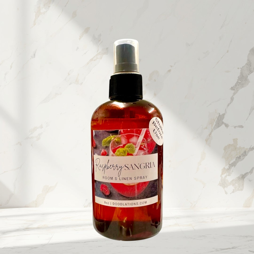 Doodlations Raspberry Sangria room and linen spray in a dark amber bottle with a spray nozzle.