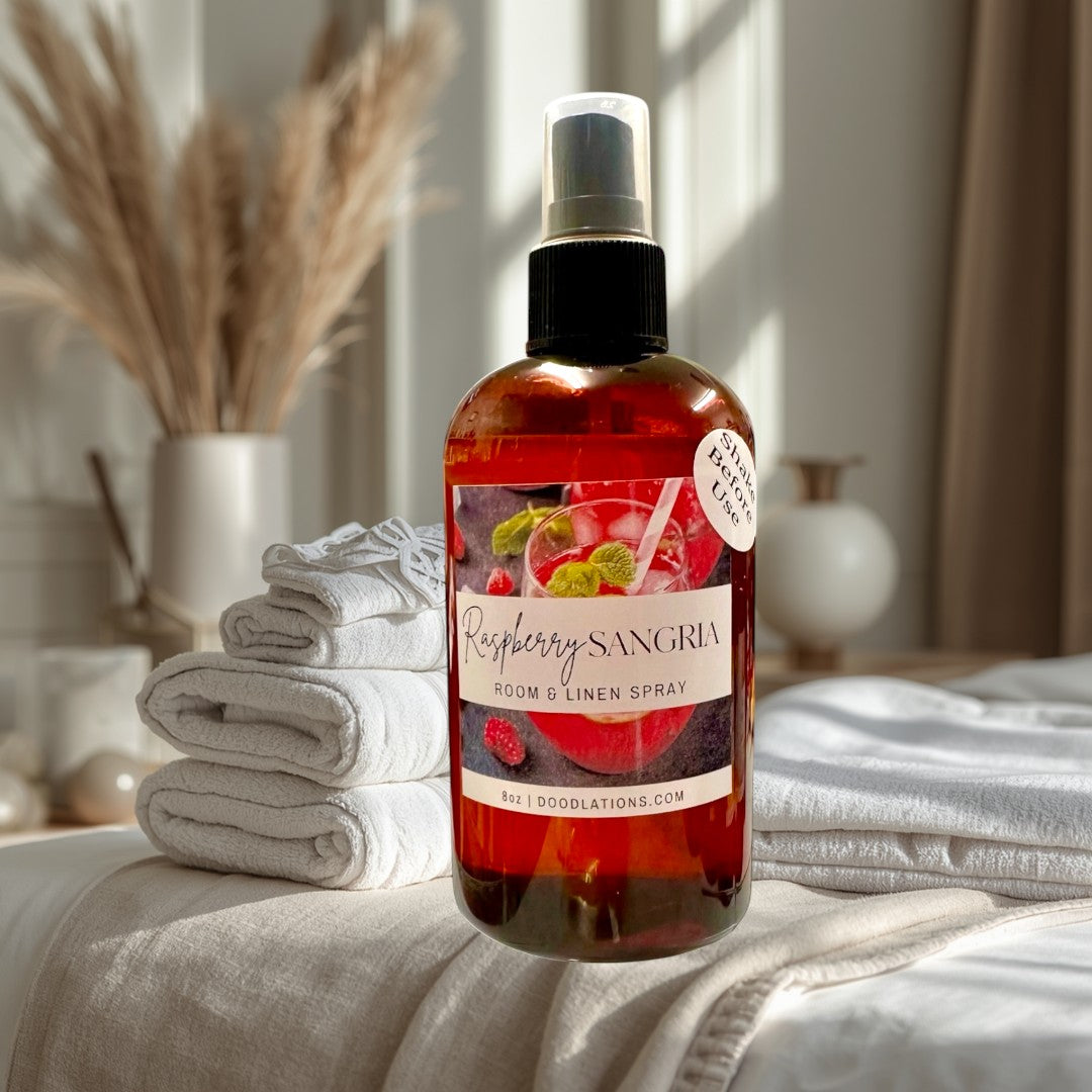 Doodlations Coffee Bar & Boutique Raspberry Sangria Room & Linen Spray with raspberry and mint garnish.