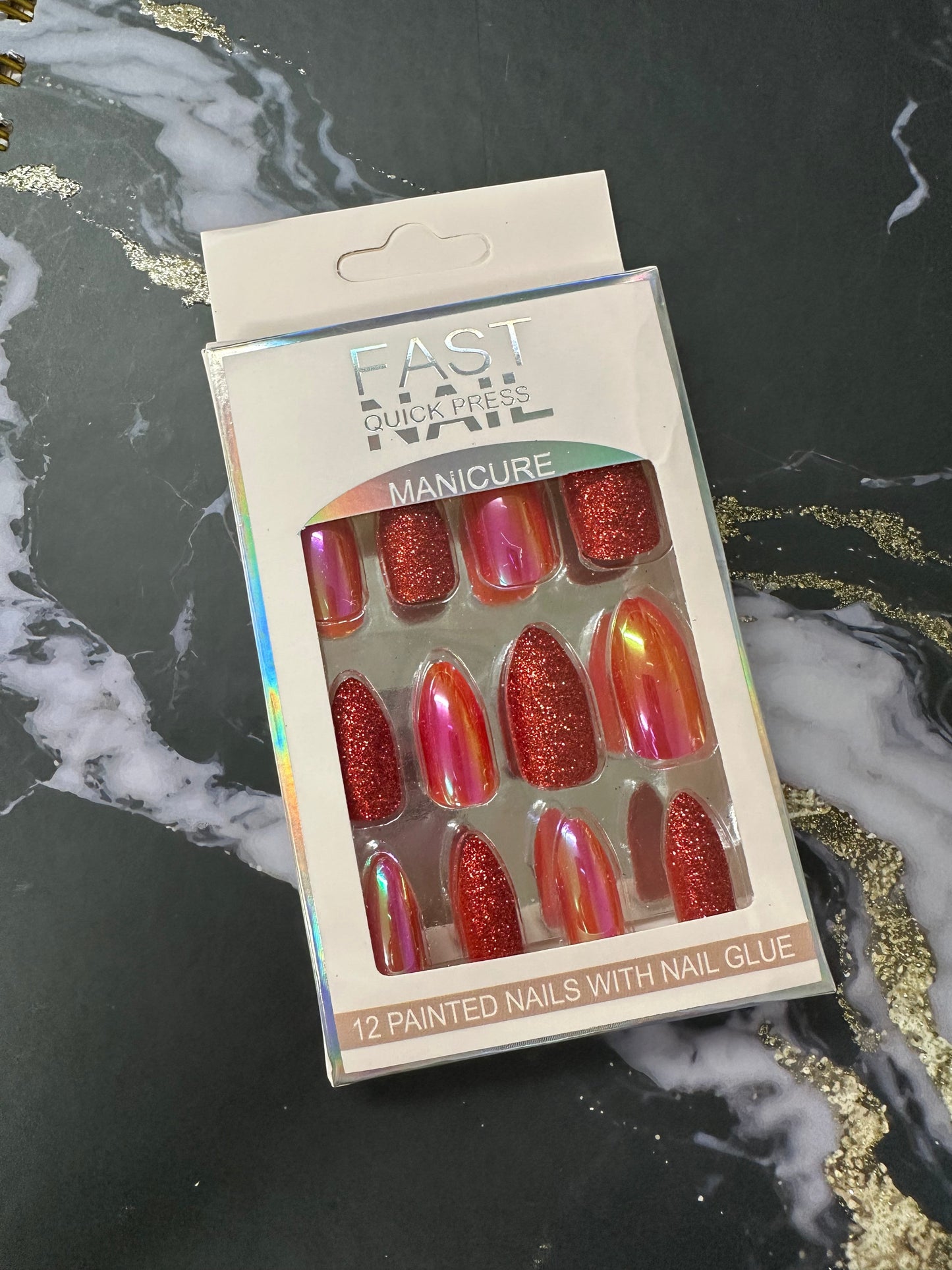 Doodlations Coffee Bar & Boutique Fast Nails Quick Press Manicure set featuring 12 red chrome and glitter press-on nails.