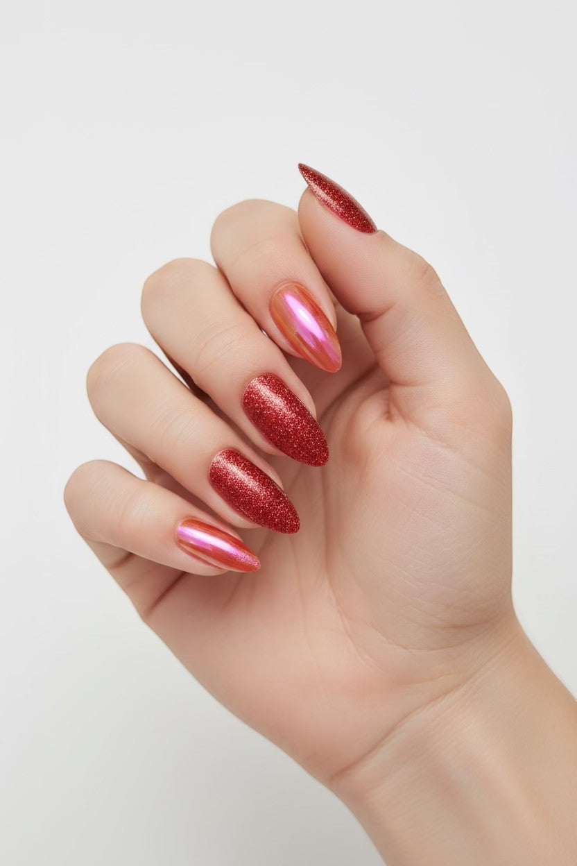 Doodlations Coffee Bar & Boutique red glitter and chrome almond press-on nails with iridescent finish.