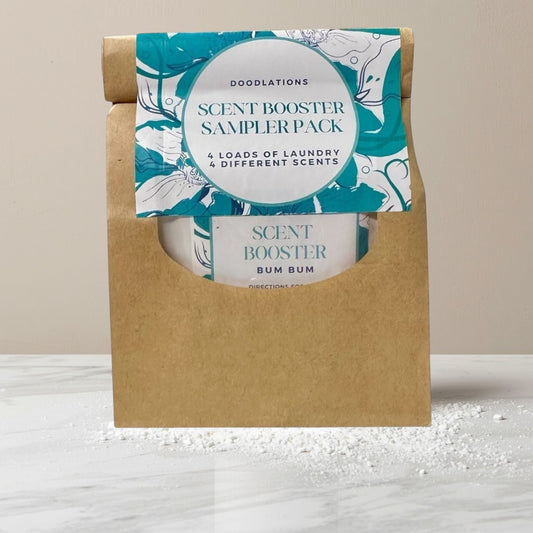 Doodlations Scent Booster Sampler Pack with 4 different laundry scents in individual packets inside a brown paper pouch.
