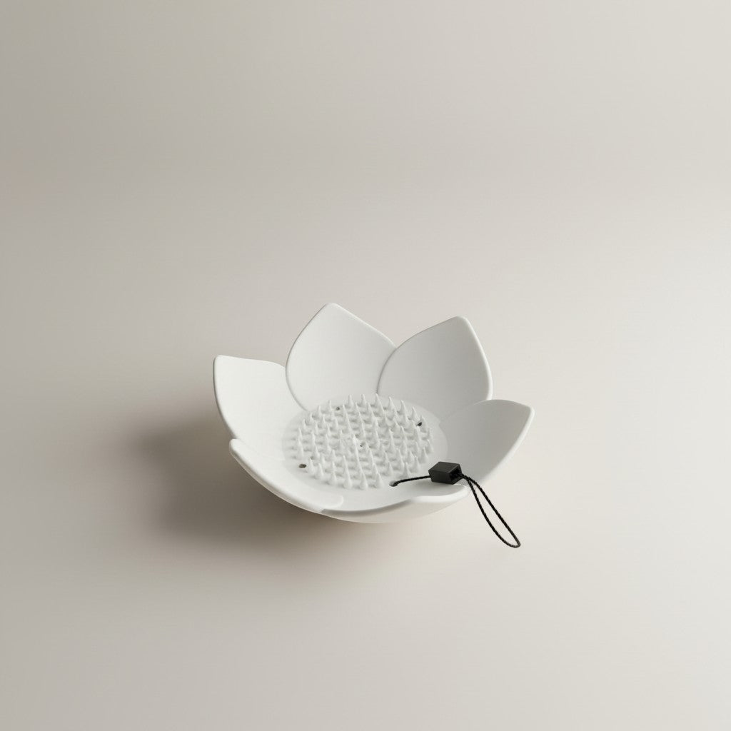 Doodlations Coffee Bar & Boutique white silicone lotus flower shower steamer holder with drainage spikes and hanging cord.