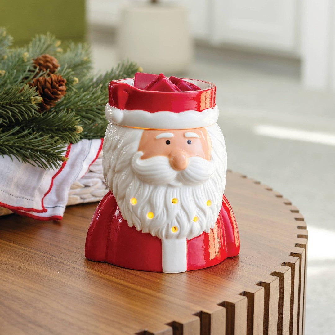 Doodlations St. Nick fragrance warmer shaped like Santa Claus, with red suit and white beard, emitting a warm glow.