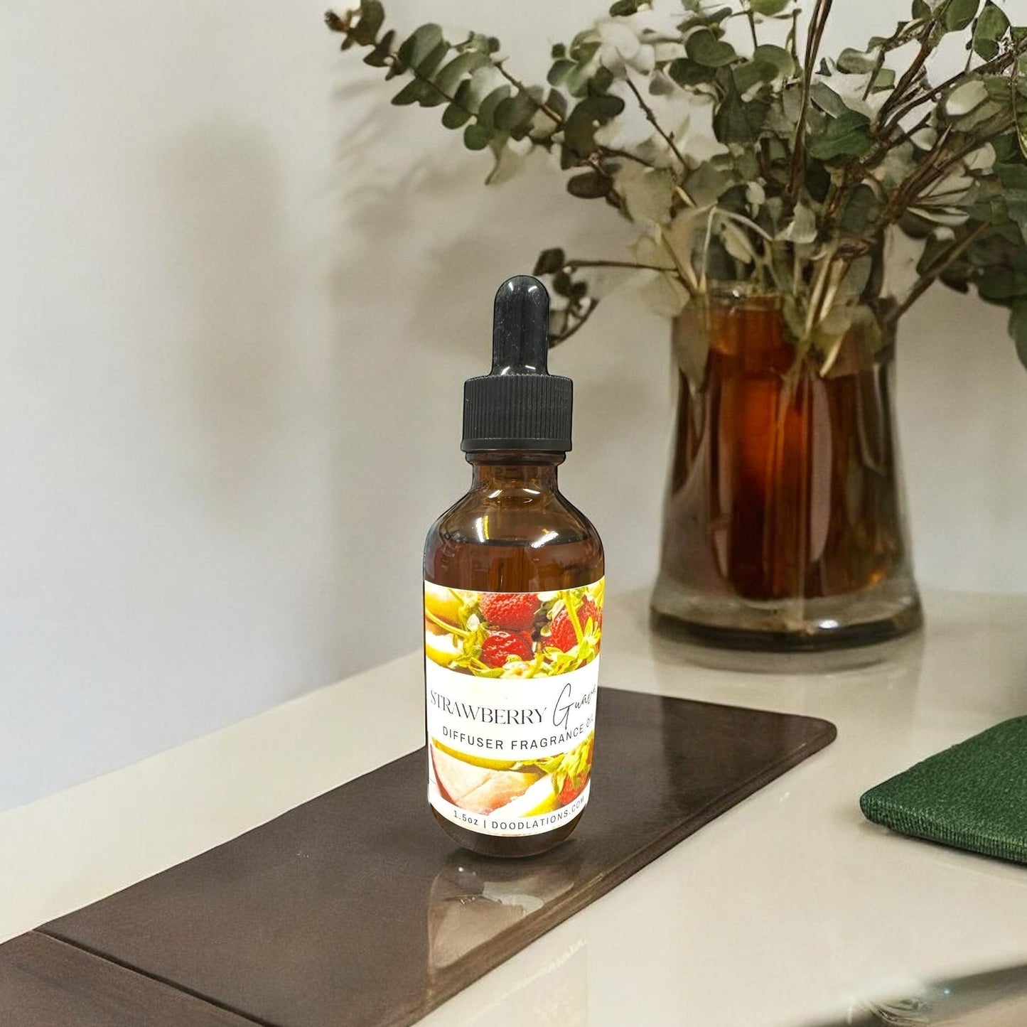 Doodlations Coffee Bar & Boutique Strawberry Guava 1.6oz diffuser fragrance oil in amber glass bottle with dropper.