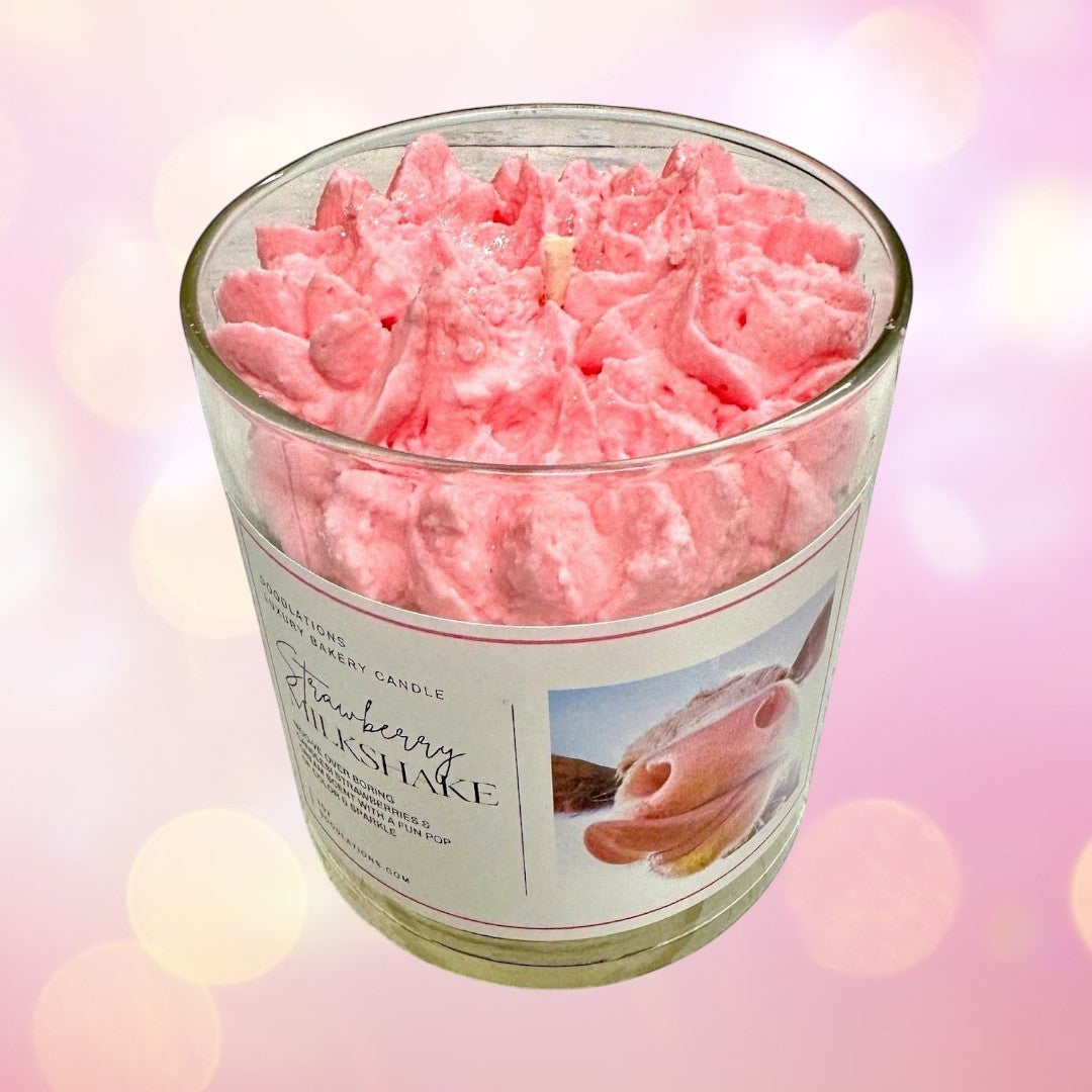 Doodlations Strawberry Milkshake Luxury Candle with pink whipped icing top in a glass jar.