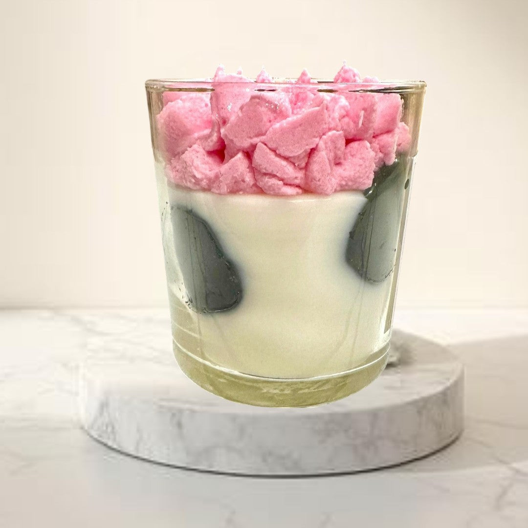 Doodlations Strawberry Milkshake Luxury Candle with pink whipped top and cow print design in glass jar.