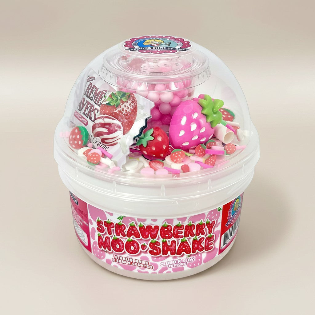 Doodlations Strawberry Moo-Shake slime with pink, white, and red swirls, strawberry charms, sprinkles, and floam beads.