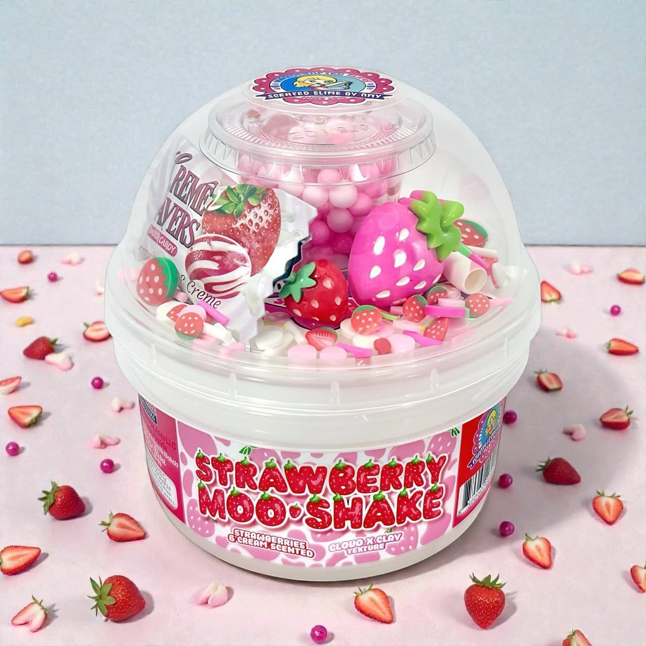 Doodlations Strawberry Moo Shake cloud clay slime with pink and white swirls, strawberry charms, and sprinkles.