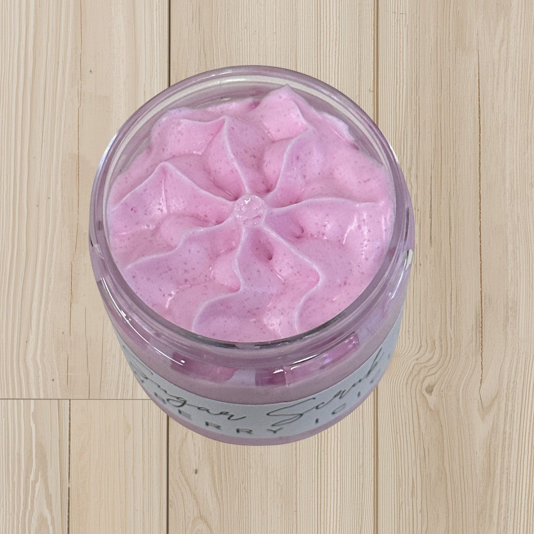 Doodlations Sugar Scrub in Snowberry Icicles scent, a pink whipped body scrub in a clear jar.